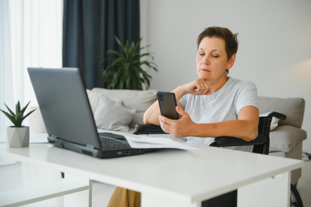 Person reviewing paperwork and a smartphone at a home desk while tracking HSA-eligible expenses for healthcare costs.