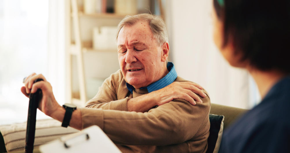 Older man experiencing hand tremors while performing daily activity, illustrating Essential Tremor and the need for natural, drug-free treatment options