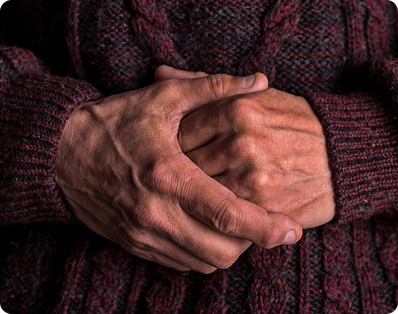 Focused ultrasound for essential tremor, where a doctor uses medical equipment on the patient's hands in a clinical setting.